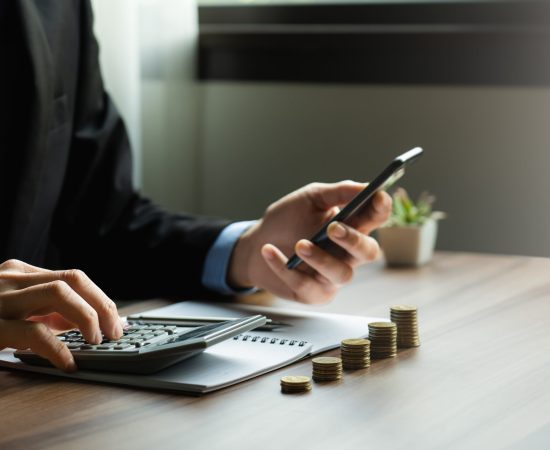 Businessman calculates investment income, financial business investments analyze risks, research companies, consult experts, plan wisely for financial goals. insurance companies, mutual funds, stocks